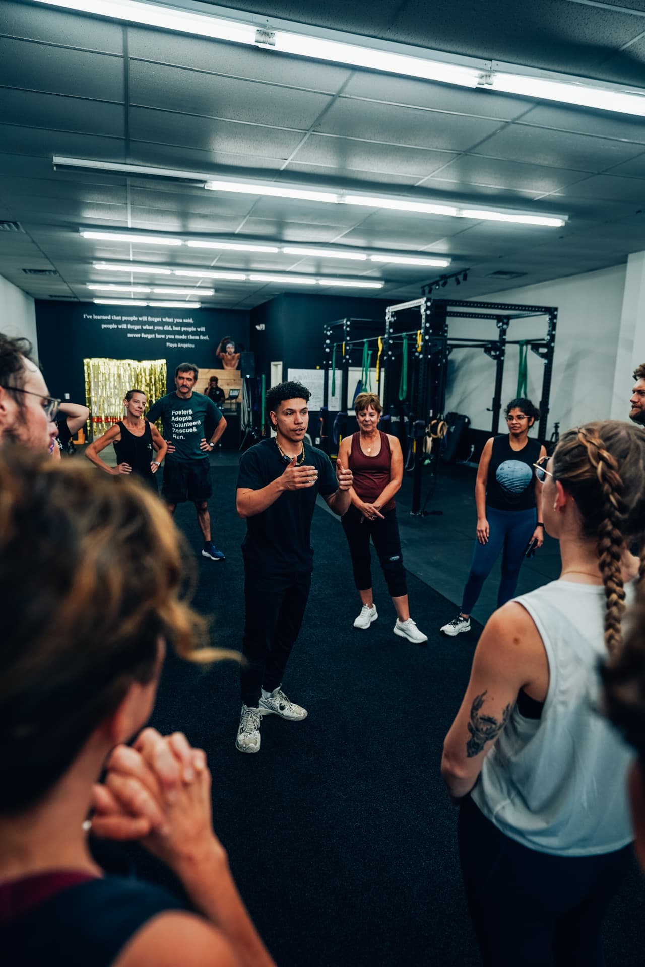 Coach briefing an adult small group before a session at On The Move Fitness